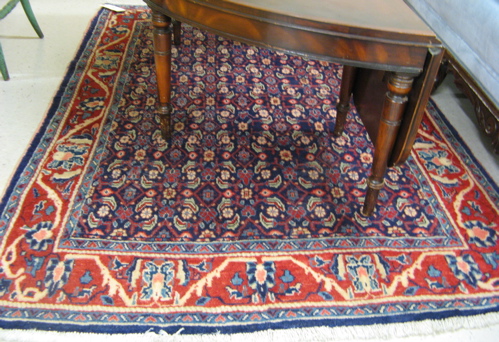 Appraisal: PERSIAN AREA RUG overall Herati floral design on blue ground