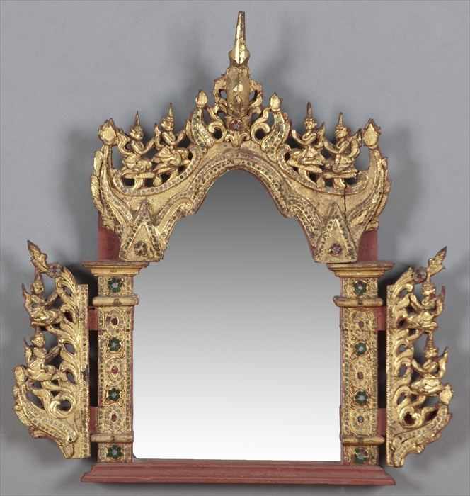 Appraisal: THAI PARCEL-GILT RED-PAINTED AND GLASS-INSET CARVED WOOD WALL MIRROR The