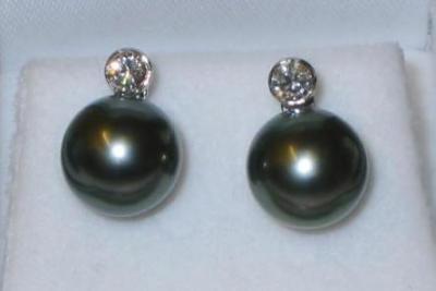 Appraisal: A PAIR OF TAHITIAN BLACK PEARL EAR STUDS the pearl