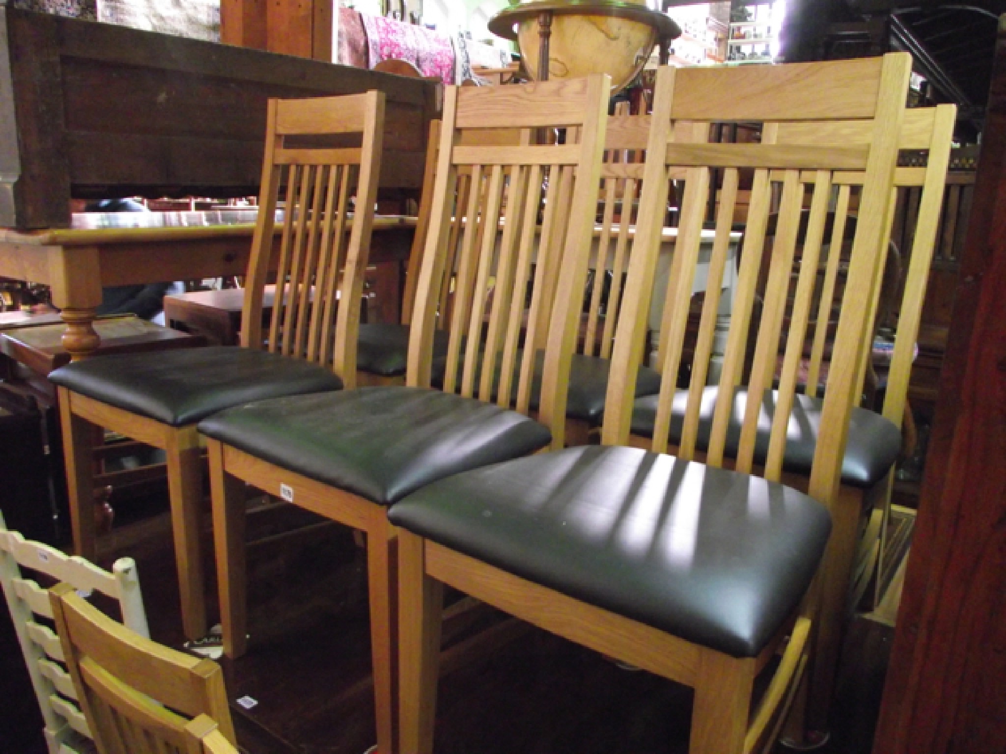 Appraisal: A set of eight oak framed stick back dining chairs