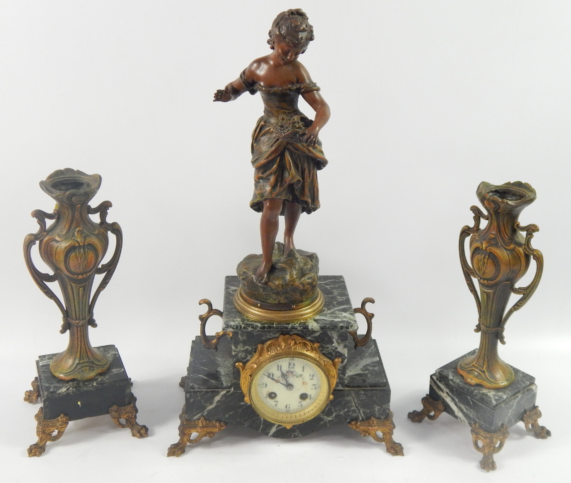 Appraisal: A French marble and spelter mantel clock garniture clock surmounted