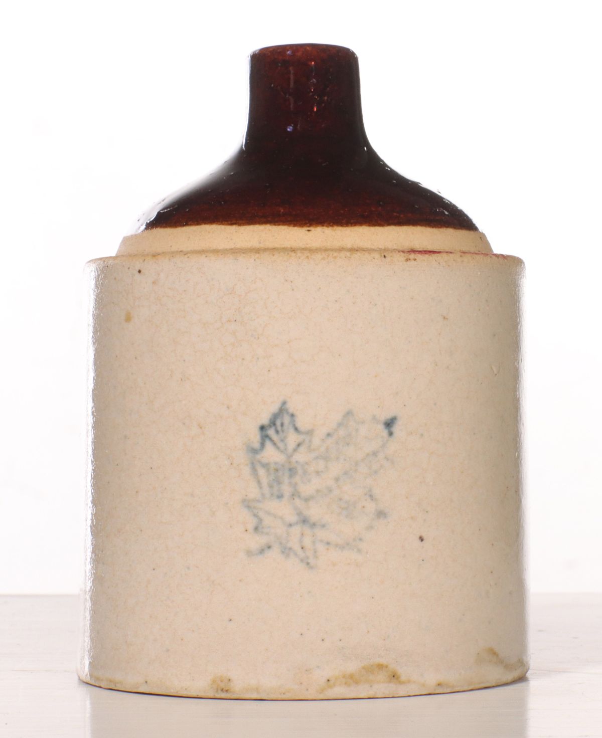 Appraisal: A WESTERN STONEWARE JUG-FORM STRING HOLDER WITH LEAFThe shoulder jug