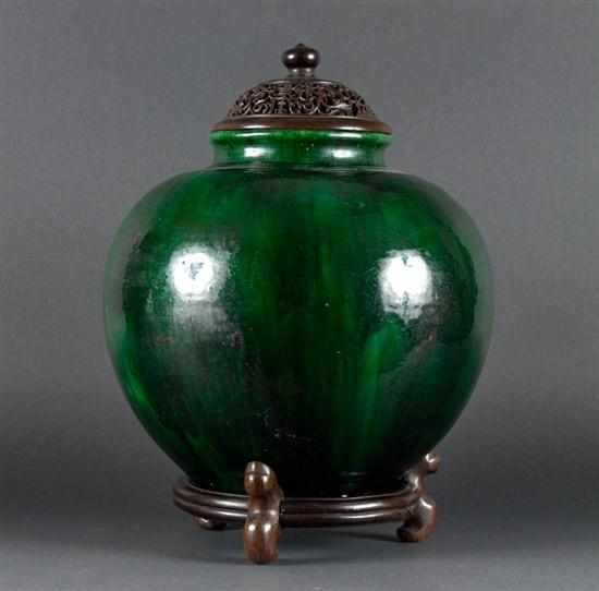 Appraisal: Chinese green glaze terracotta jar with carved reticulated wood lid