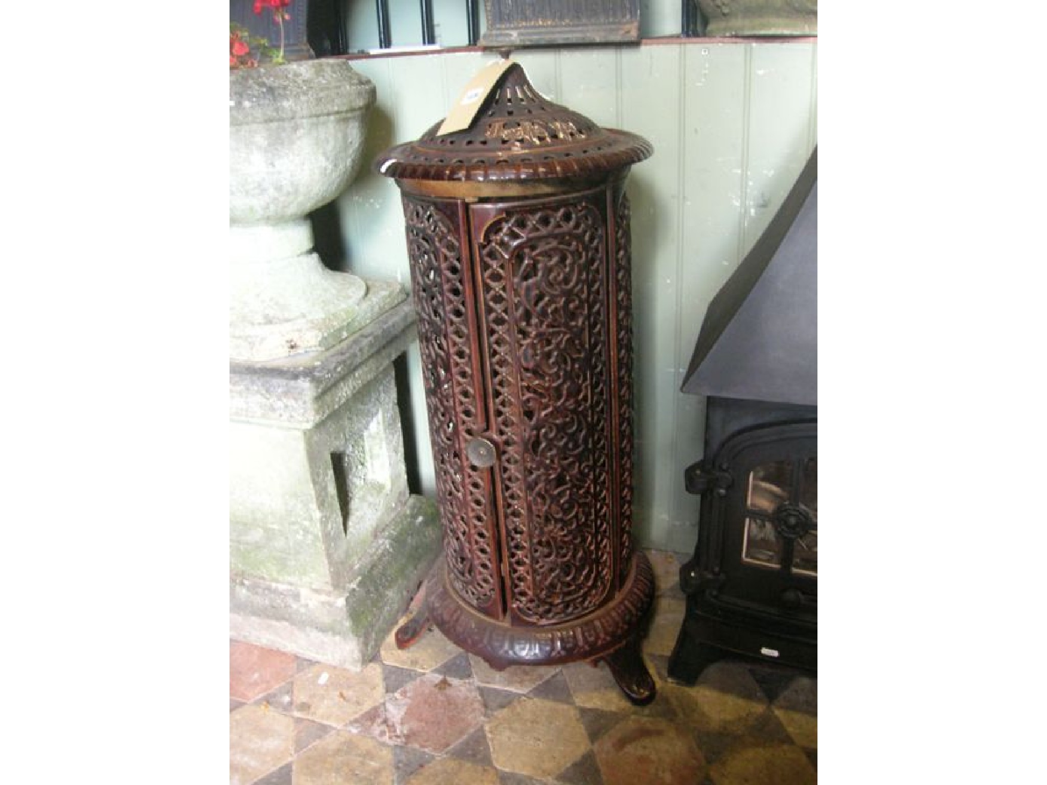 Appraisal: A vintage cast iron and enamel conservatory heater of cylindrical