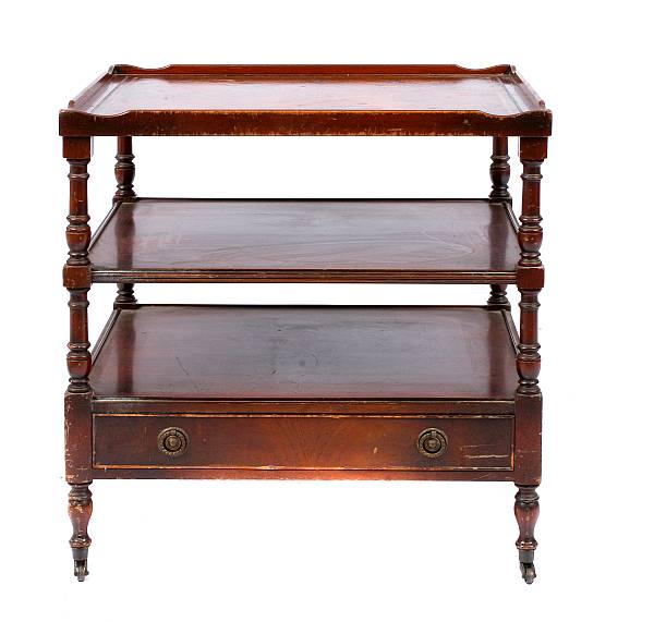 Appraisal: A pair of George III style leather topped tiered side