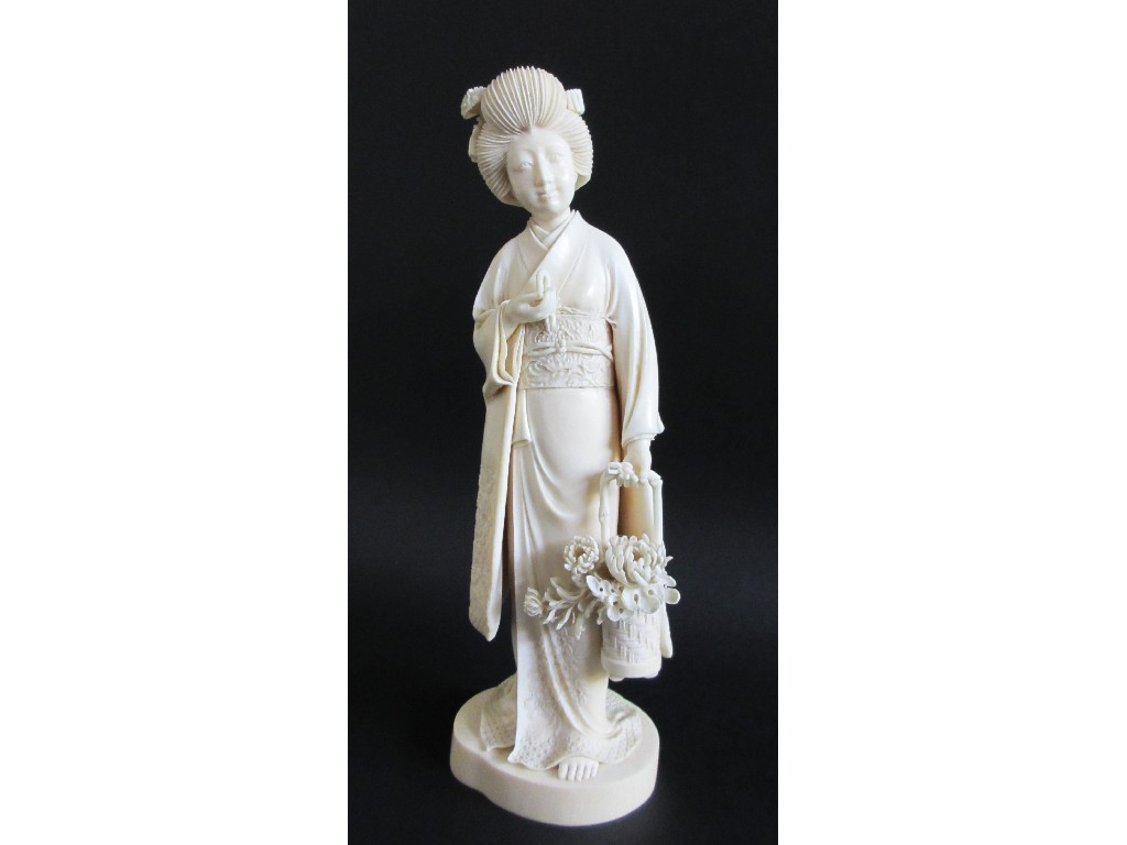 Appraisal: A Japanese carved ivory figure of a lady wearing a