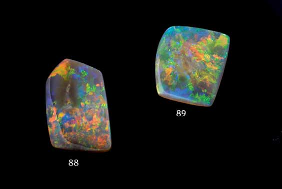 Appraisal: DARK-BASED OPAL CABOCHON Mintabie Australia This crest-shaped opal cabochon is