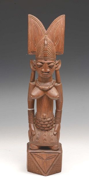 Appraisal: AN AFRICAN CARVED WOOD FEMALE FIGURE kneeling on a plinth