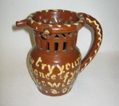 Appraisal: A VICTORIAN SLIPWARE PUZZLE JUG probably North Country of typical