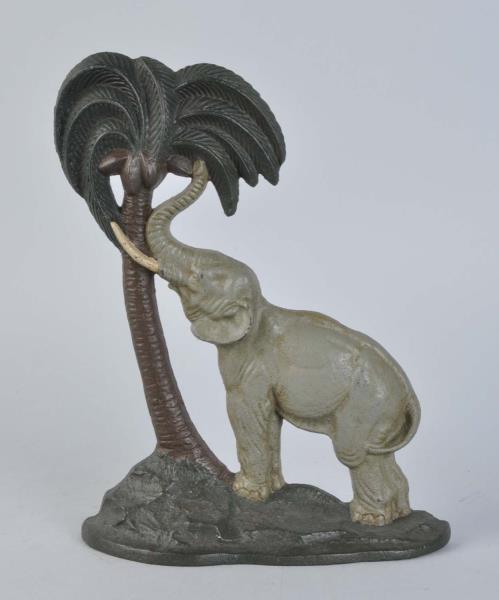 Appraisal: Cast Iron Elephant By Coconut Tree Doorstop Marked A M