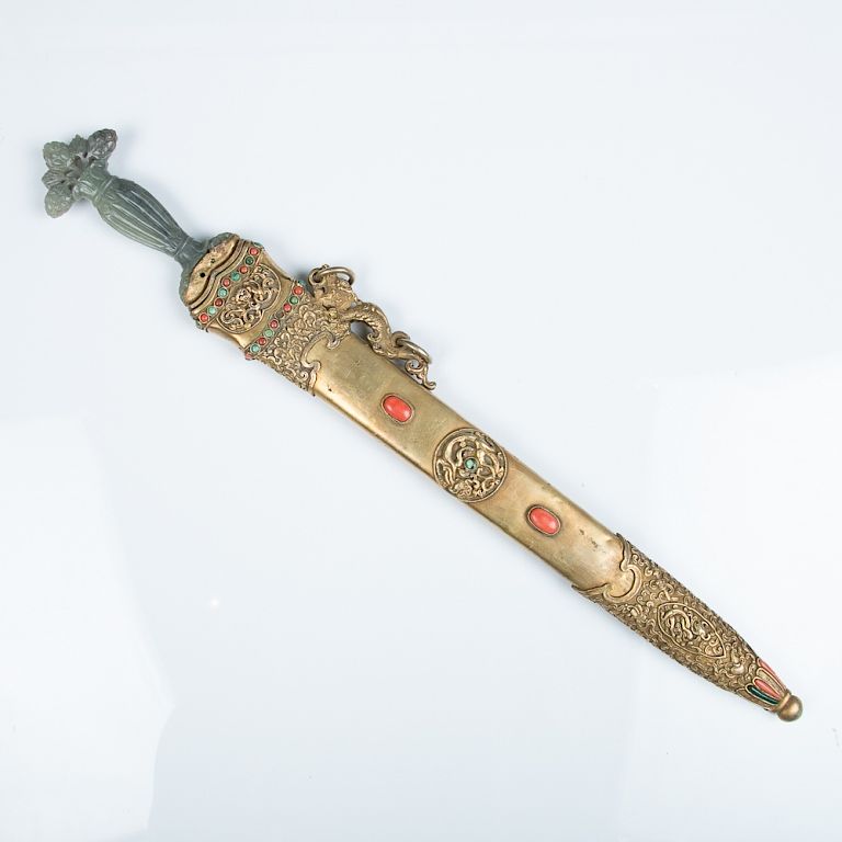 Appraisal: A TURQUOISE AND CORAL INLAID SWORD Flanked with hanging ear