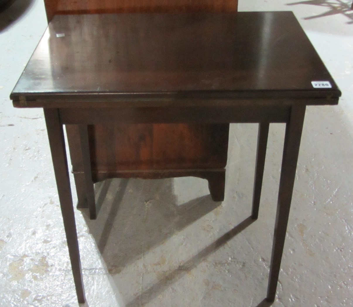 Appraisal: A th century mahogany fold over card table