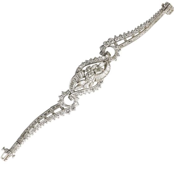 Appraisal: DIAMOND PLATINUM COCKTAIL BRACELET Central lozenge shaped bosse of bypass