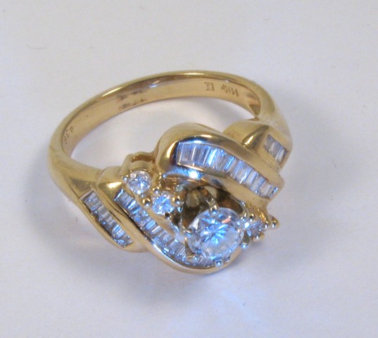 Appraisal: DIAMOND AND FOURTEEN KARAT GOLD RING centering a round brilliant-cut