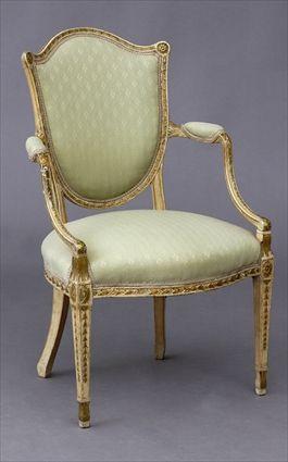 Appraisal: GEORGE III CARVED PAINTED AND PARGEL-GILT SHIELD-BACK ARMCHAIR The padded