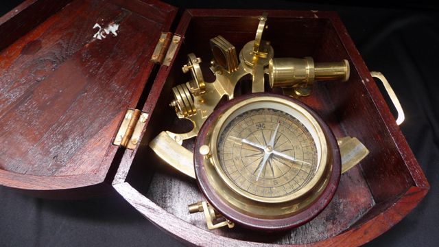 Appraisal: A reproduction brass sextant and compass comes with wood case