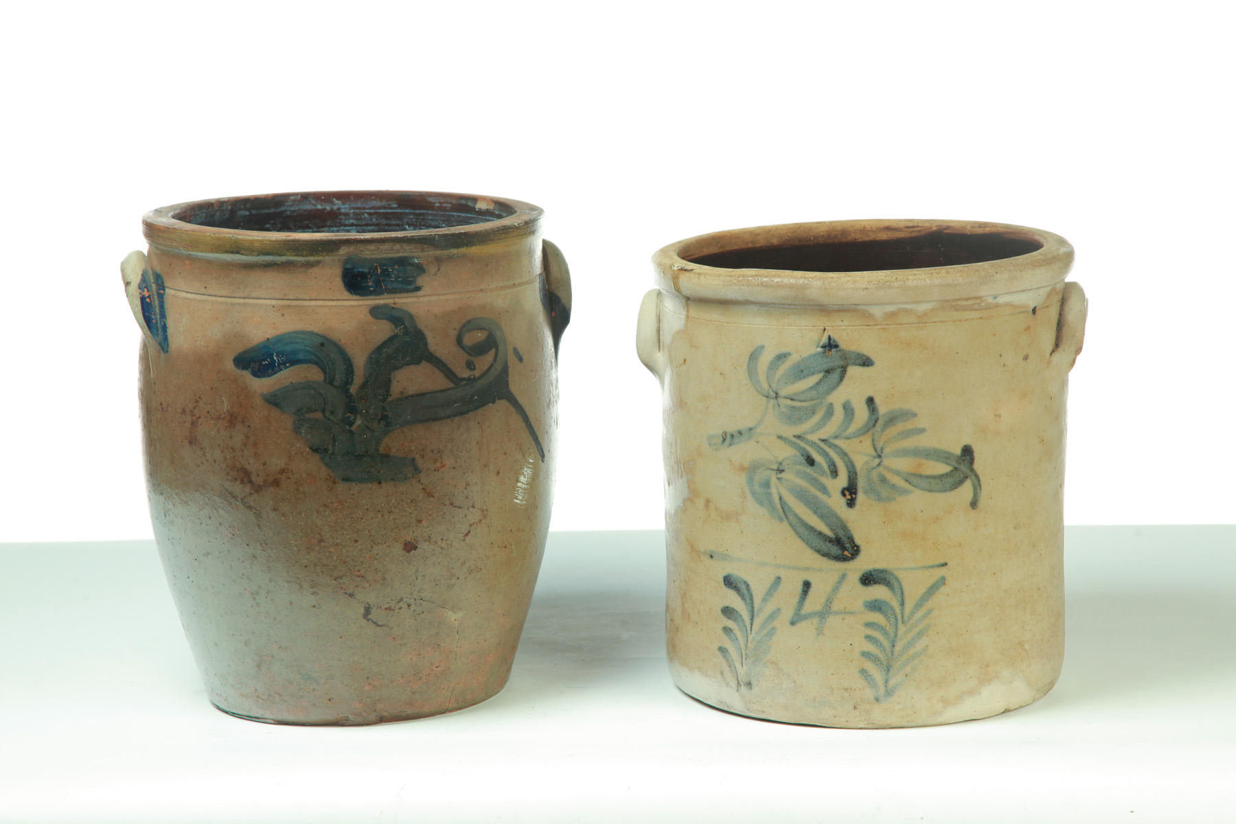 Appraisal: TWO FOUR-GALLON STONEWARE JARS WITH FREEHAND COBALT DECORATION American th