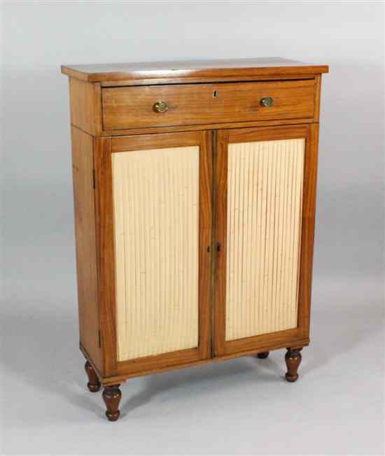 Appraisal: A Regency satinwood cabinet with drawer and two cupboard doors