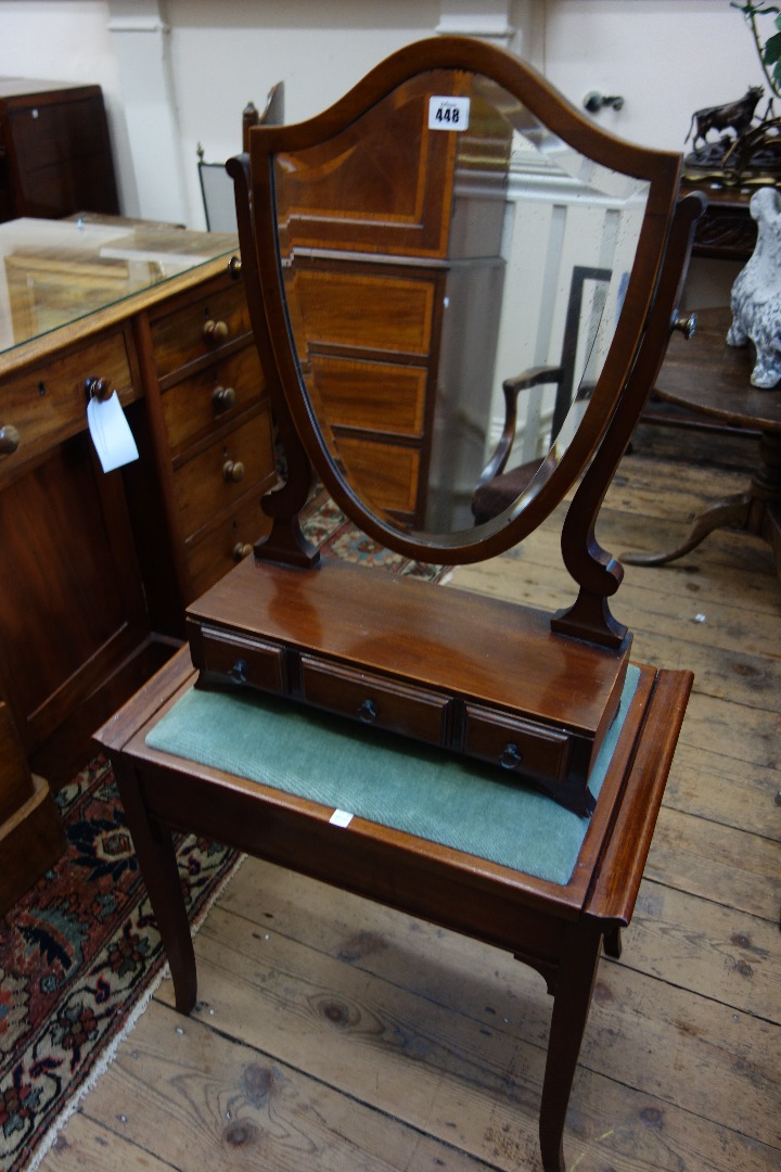 Appraisal: An Edwardian mahogany boxwood banded swing toilet mirror shield shape