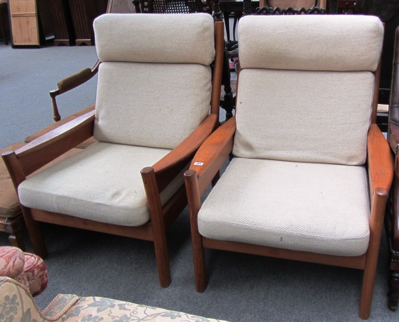 Appraisal: A pair of th century teak framed lounge chars by