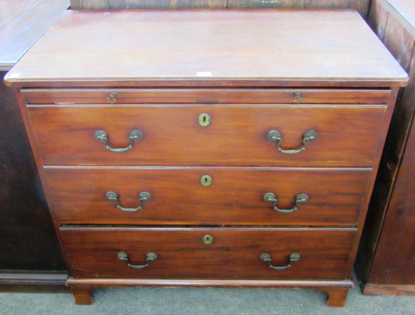 Appraisal: A George III mahogany chest of three long graduated drawers