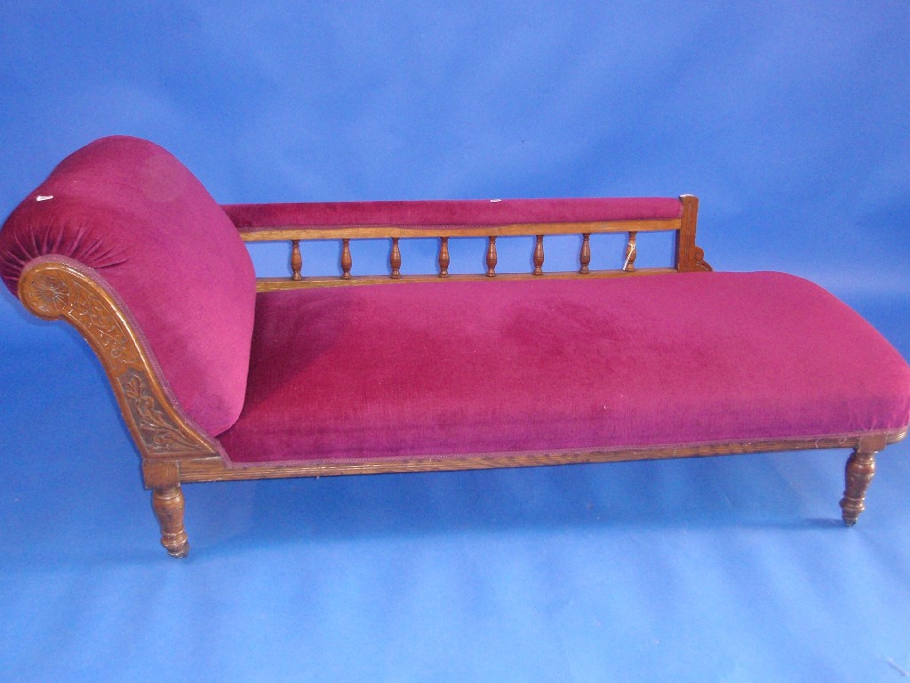 Appraisal: A Victorian oak framed and galleried chaise longue