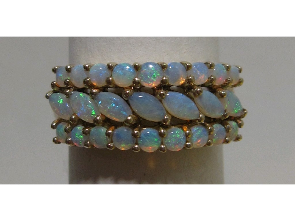 Appraisal: Nine carat gold triple row opal set dress ring