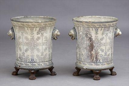 Appraisal: PAIR OF ENAMELED CAST IRON JARDINI RES Each ivory-ground beaker-form