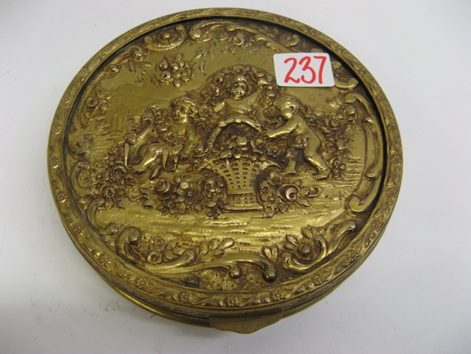 Appraisal: APOLLO ROUND GILT METAL REPOUSSE TRINKET BOX The hinged lid