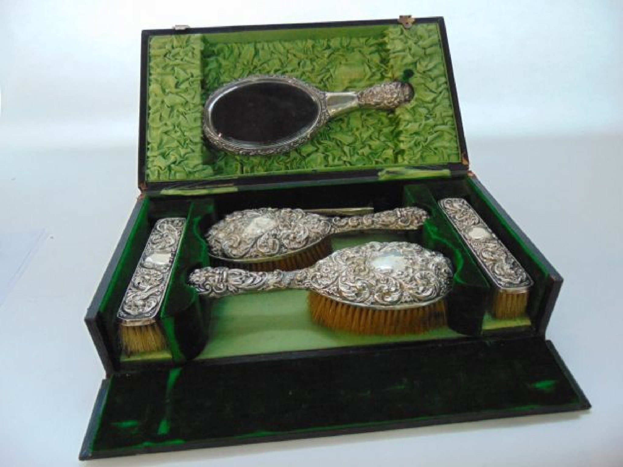 Appraisal: A cased Edwardian silver dressing set Walker Hall Sheffield comprising