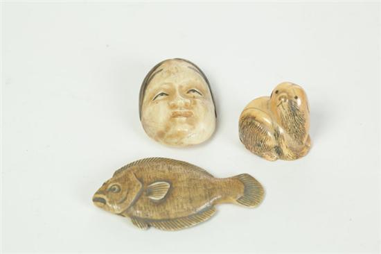 Appraisal: THREE IVORY NETSUKES Japan st half- th century Mask fish