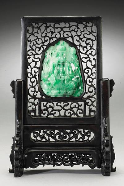 Appraisal: A mottled green and white jadeite plaque depicting Guanyin th