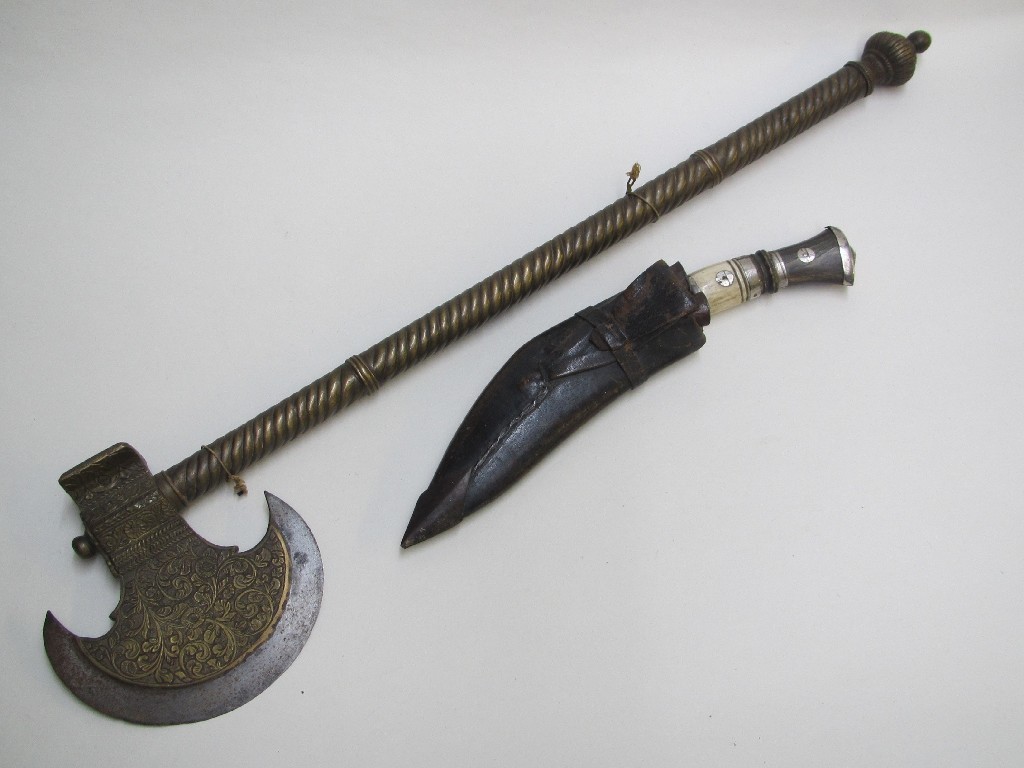 Appraisal: An Indian brass and steel axe the crescent shaped head