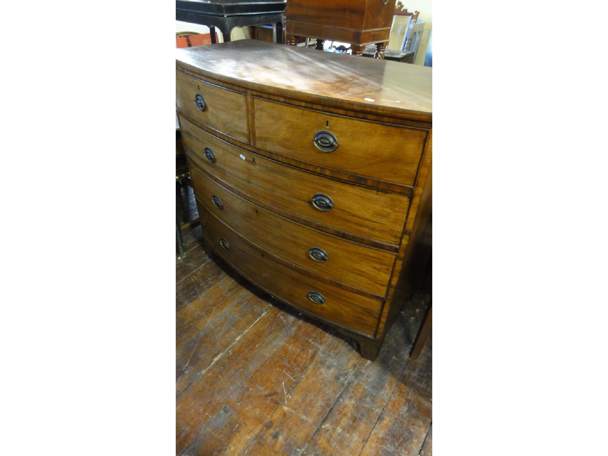 Appraisal: A th century mahogany bow fronted chest of three long