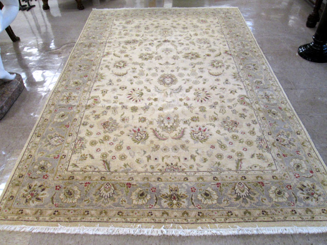 Appraisal: HAND KNOTTED ORIENTAL CARPET Pakistani-Persian overall floral decoration on khaki