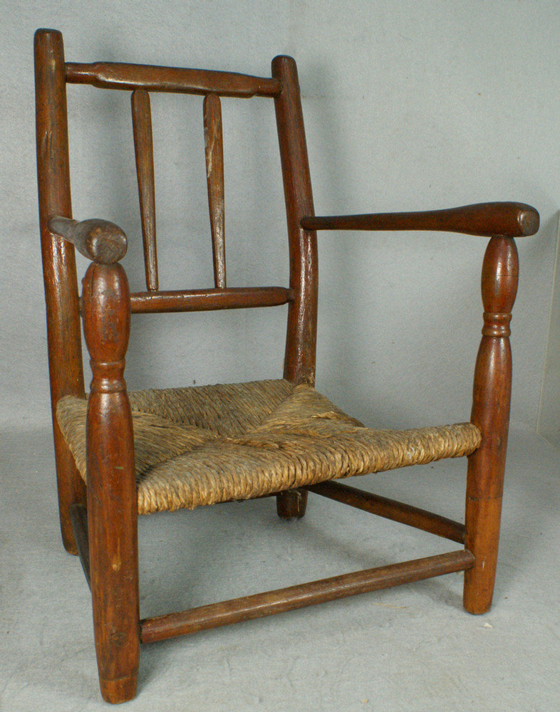 Appraisal: Oak and maple spindle back rush seat miniature armchair old