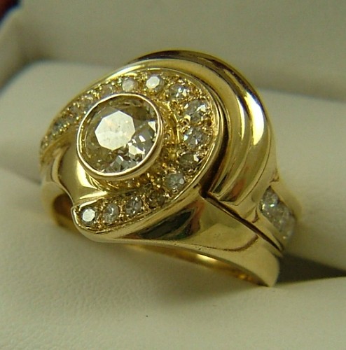 Appraisal: DIAMOND AND FOURTEEN KARAT GOLD RING centering a round-cut diamond