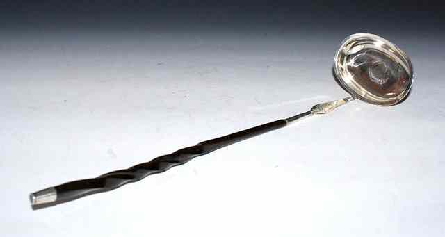 Appraisal: A PUNCH LADLE with inset silver coin and twisted whale