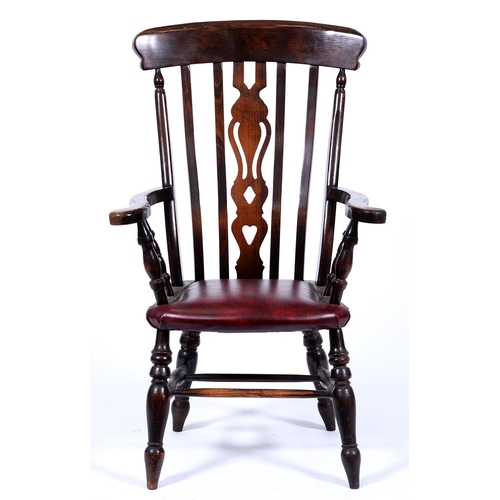 Appraisal: A stained wood elbow chair with pierced splat More Information