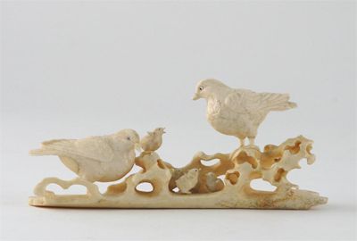 Appraisal: A bone and ivory carving of two birds with five