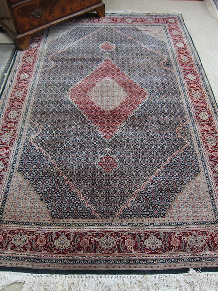 Appraisal: HAND KNOTTED ORIENTAL WOOL SILK CARPET Sino-Tabriz overall Herati floral