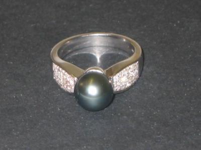 Appraisal: A BLACK PEARL AND DIAMOND RING the cultured single pearl