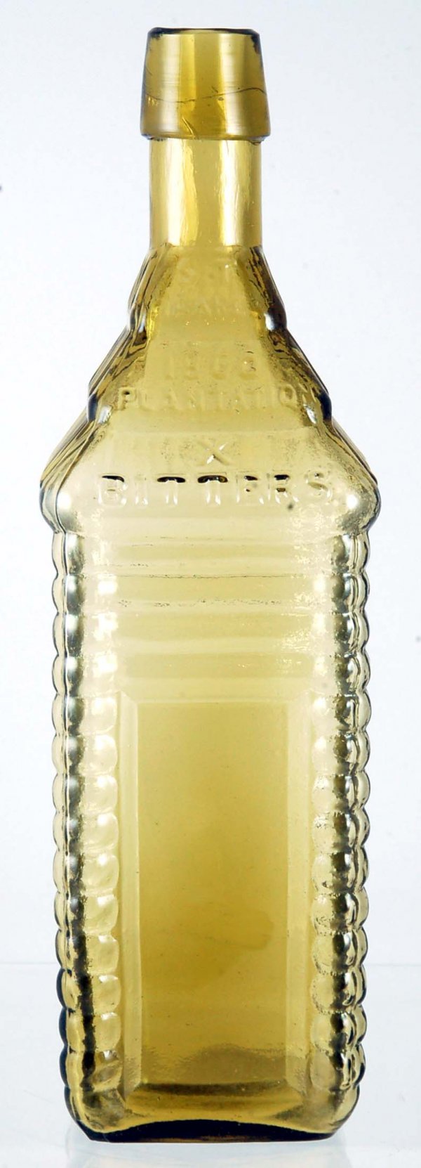 Appraisal: Yellow figural bitters bottle In the form of a log