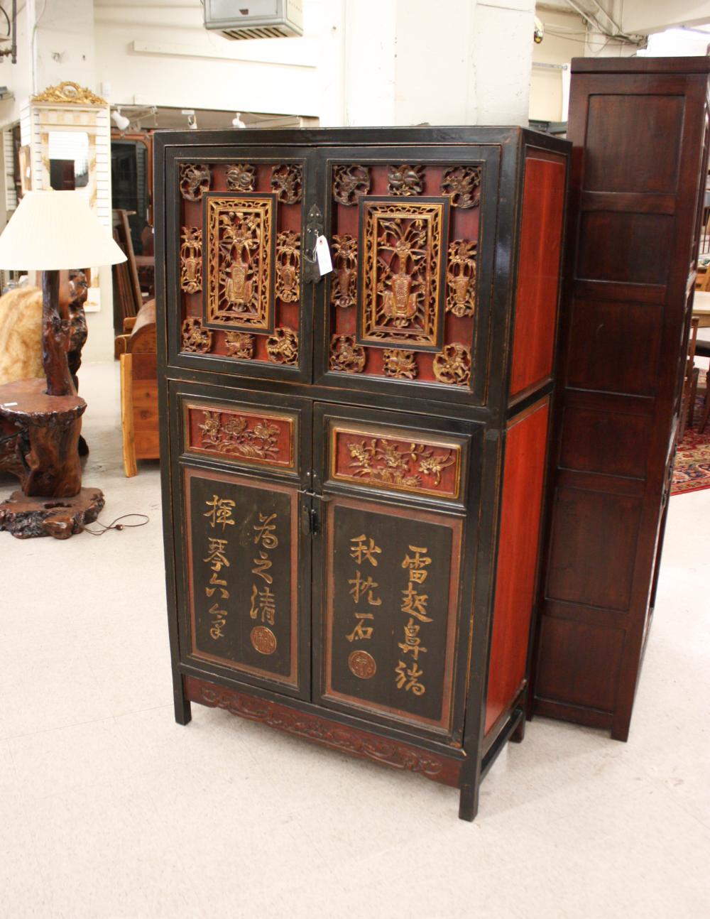 Appraisal: CHINESE FOUR-DOOR CABINET having relief-carved giltwood panels along with red