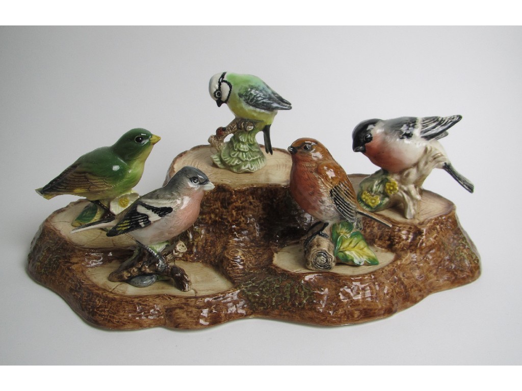 Appraisal: A Beswick group of birds perched on a tree stump