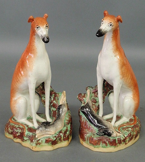 Appraisal: Pair of Staffordshire seated whippets with hare marked Old Staffordshire