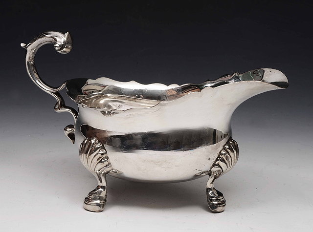 Appraisal: A Georgian style silver sauce boatof baluster form on shaped