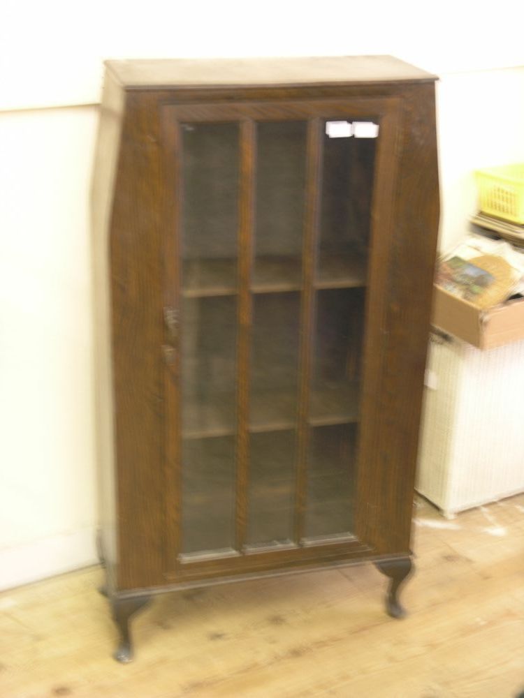 Appraisal: A dark oak veneered display cabinet enclosed by single glazed