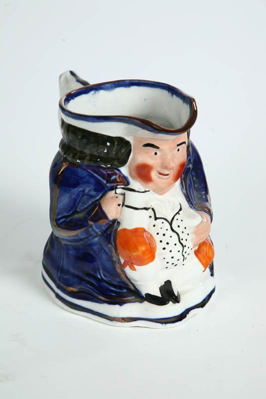 Appraisal: STAFFORDSHIRE TOBY PITCHER Seated gentleman in blue with mug and