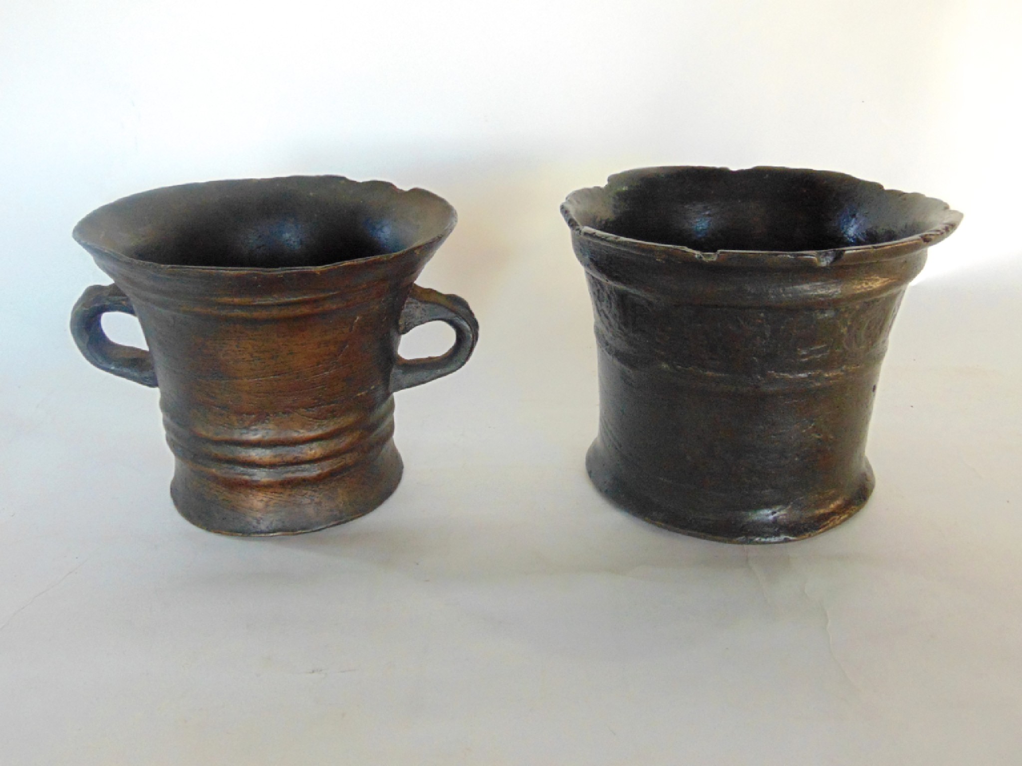 Appraisal: An early cast bronze mortar with flared rim and scripted